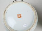 a close up of a vase with a tag on it