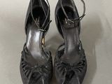 pair of black high heeled shoes on a white surface