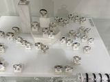 a display of rings and bracelets on display in a glass case