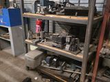 a shelf of tools in a garage next to a blue machine
