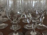 several empty wine glasses sitting on top of a wooden table