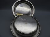 a silver container with a lid on a table
