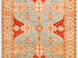 a blue and red rug with an ornate design