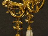 a gold and pearl earring with an elephant on it