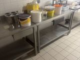 many pots and pans sitting on a stainless steel table