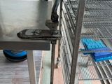 a metal table that is on a shelf in a room