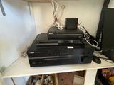 a lot of electronics on a shelf in a room