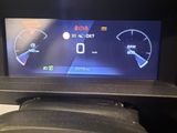 the dashboard of a car with a digital display on it