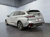 the rear end of a silver car parked in a garage