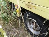 a yellow truck that is parked in the grass
