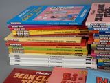 several children ' s books stacked on top of each other on a table