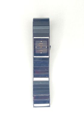 an image of a watch on a white surface with a white background