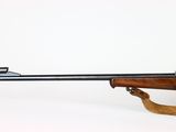 a rifle with a wooden barrel on a white background