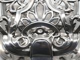 a close up of a silver object with a black handle