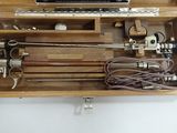 a wooden box with tools in it on a white surface