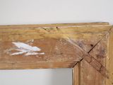a wooden frame with a picture of a bird painted on it