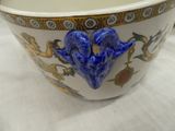 a blue and white bowl sitting on a white table