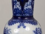 a blue and white vase sitting on a table