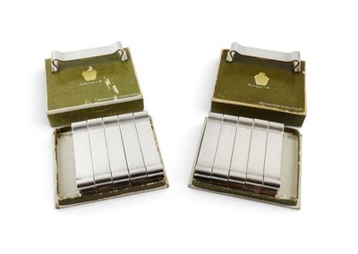 two boxes of cigarettes sitting next to each other on a white surface