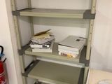 a shelf that has a bunch of books on top of it