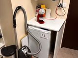 a small kitchen with a microwave, dishwasher, and a dishwasher