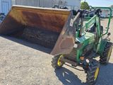 a small tractor with a bucket on the back of it