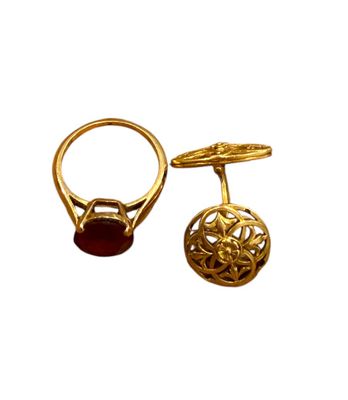 pair of gold rings with garnets and garnets on them