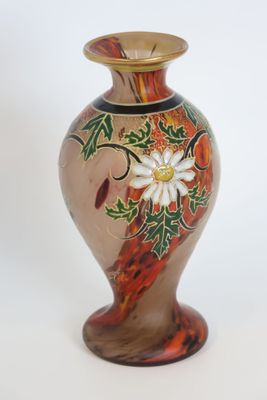 a glass vase with a flower on it on a white background