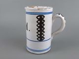 a coffee cup with a black and white design on it