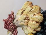 a ceramic rooster figurine sitting on a table