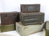 several military boxes are stacked on top of each other on a table