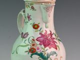 a white vase with a floral design on it
