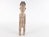 an old wooden statue of a man with a hat on his head