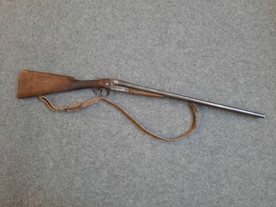 a rifle with a wooden handle and a leather sheath