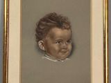 portrait of a baby in a gold frame on a gray background