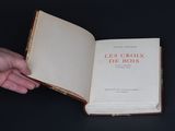a person holding a book open on a table