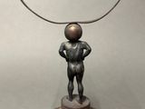 bronze sculpture of a man standing on top of a metal object