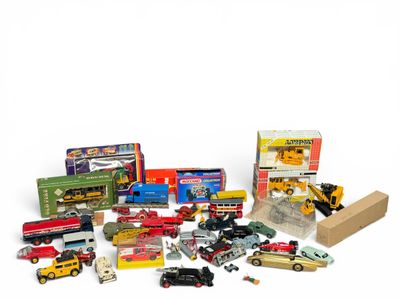 a lot of toy cars and trucks on a white surface