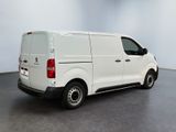 the white van is parked in the empty room of the building