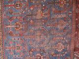 a blue and red rug with a pattern on it
