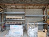 a room that has a lot of shelves and pallets in it