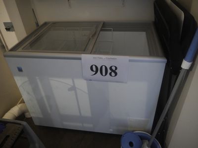 an empty freezer in the corner of a room