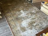 an image of a living room with a rug on the floor