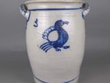 a blue and white vase with a bird on it