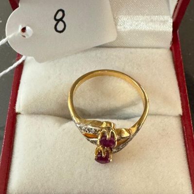 a gold ring with a ruby and diamond in it