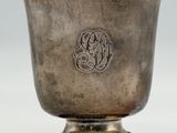an antique silver cup with a monogram on the side