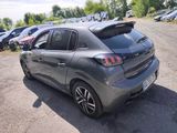 a grey car parked in a parking lot with other cars