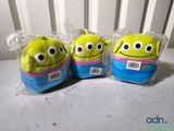 three stuffed toy balls are wrapped in plastic bags on a table