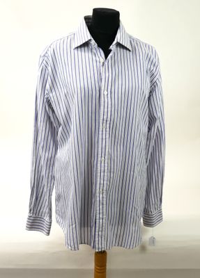 striped shirt on a mannequin stand against a white background