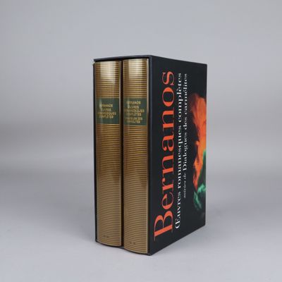 two books sitting on top of each other on a white surface